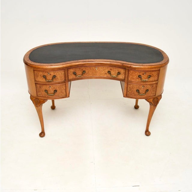 A beautiful antique burr walnut leather top kidney shaped desk. This was made in England, it dates from around the 1920’s...