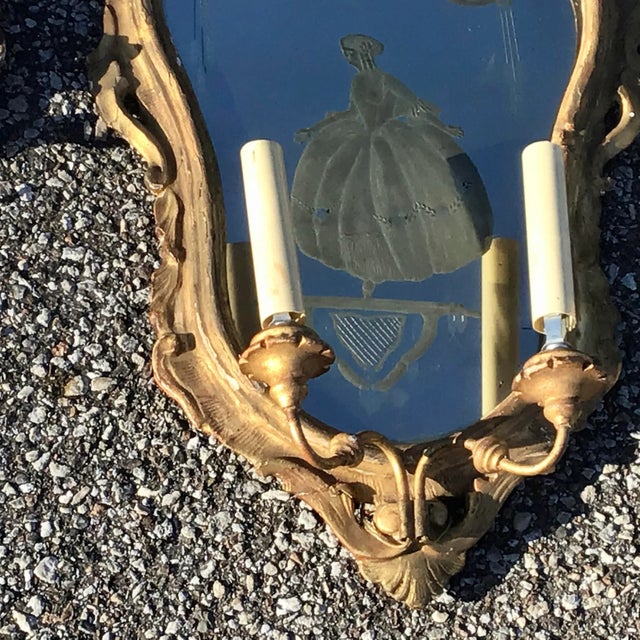 A fine early 19th century Venetian pair of carved giltwood girandole mirrors or wall sconces in the Rococo taste....