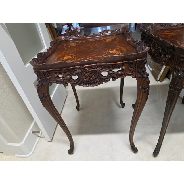 An exquisite pair of Louis XV Revival side tables, showcasing the elegance and artistry of French Rococo design....