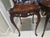 An exquisite pair of Louis XV Revival side tables, showcasing the elegance and artistry of French Rococo design....