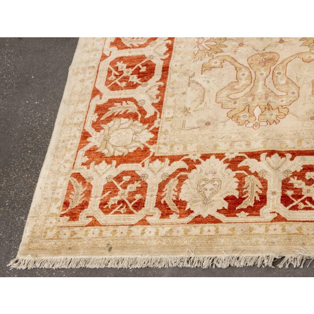 Safavieh Oushak Wool Carpet, with red and beige floral motif, label to underside. 14' 2" L x 9' 10.5" W. Provenance: From...