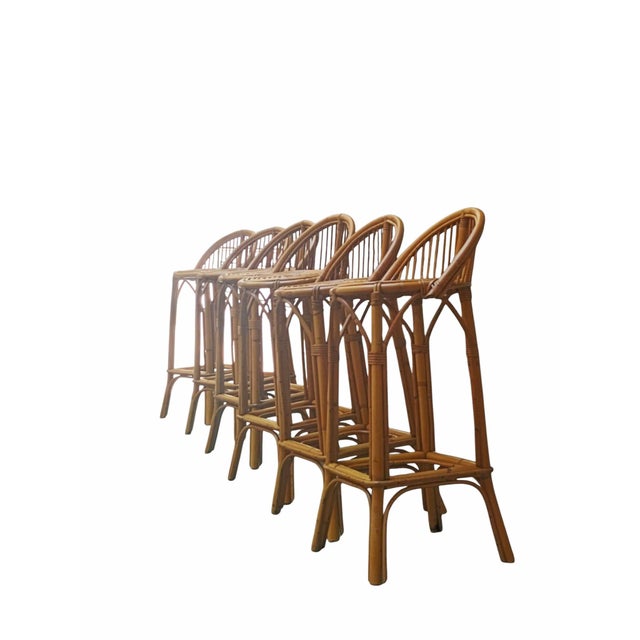 An elegant set consisting of 6 tall bar stools handcrafted from bamboo and curved rattan. They feature a sturdy structure...