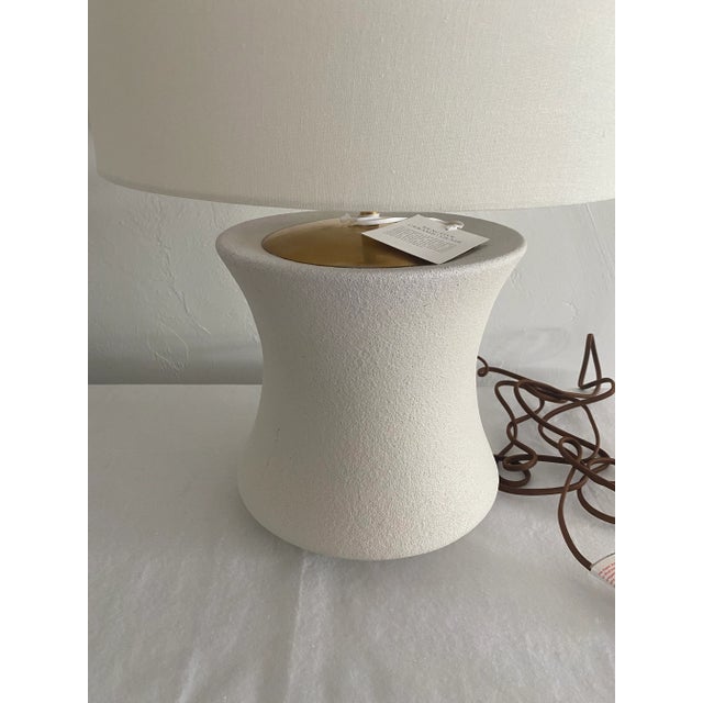 This delightful lamp brings a vintage aspect to any space, with its wide base and slight curve. Finish Porous White...