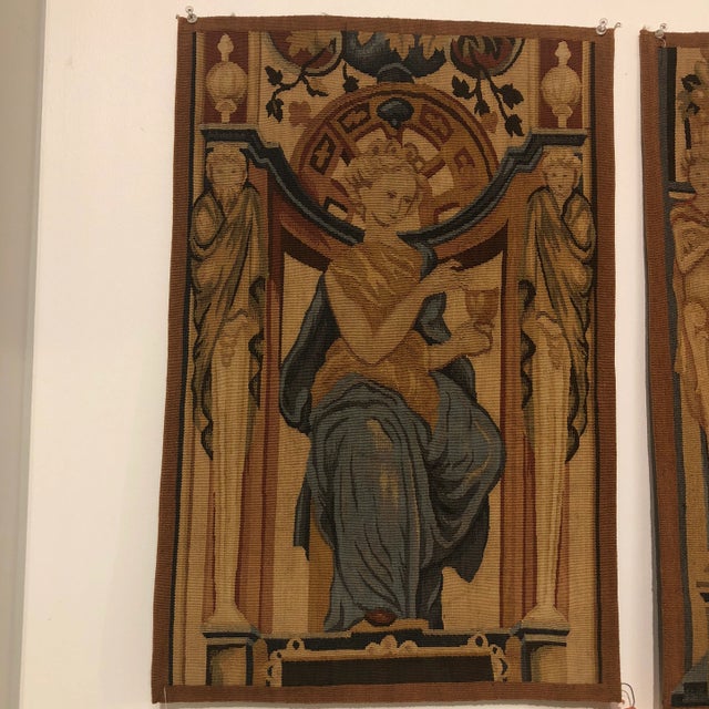 Handwoven 100% wool tapestry featuring a seated female figure holding a chalice in blue, cinnamon and gold colors.