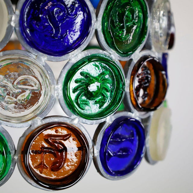 Circa 1960. We offer this hanging chandelier with colored hand made glass with zodiac motifs designed by Felipe Delfinger...