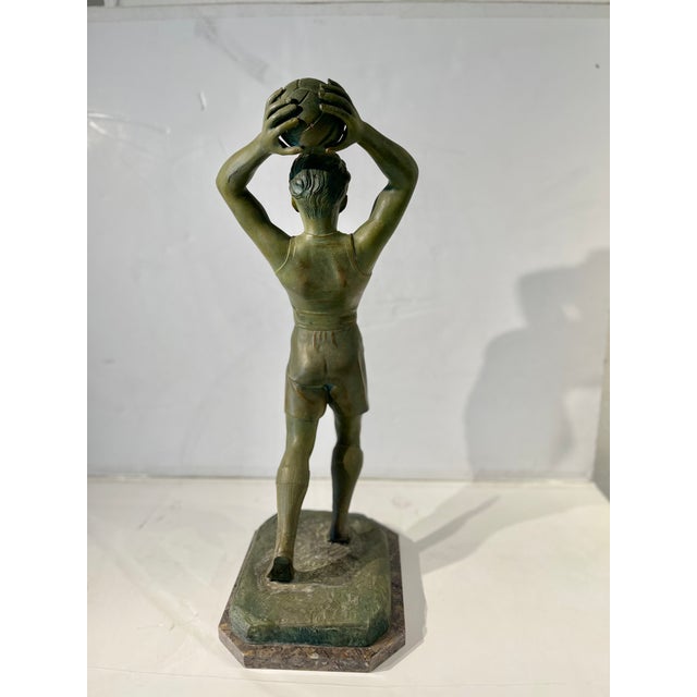 Art Deco period figure of a young athletic male arched throwing a soccer ball. This expressive, handsome piece is signed...