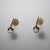 This pair of Italian wall sconces from the 1950s combines a refined modernist silhouette with rich brass surfaces and...