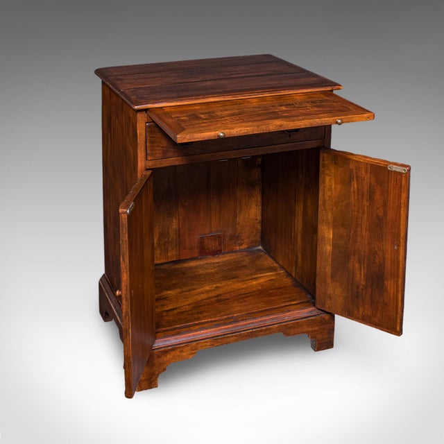 This is a vintage bachelor's writing cabinet. An English, mahogany and fruitwood correspondence stand or library cupboard...