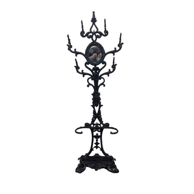 Victorian six armed Iron Hall Tree with small center mirror and two umbrella racks and one large drip tray. Mirror is face...