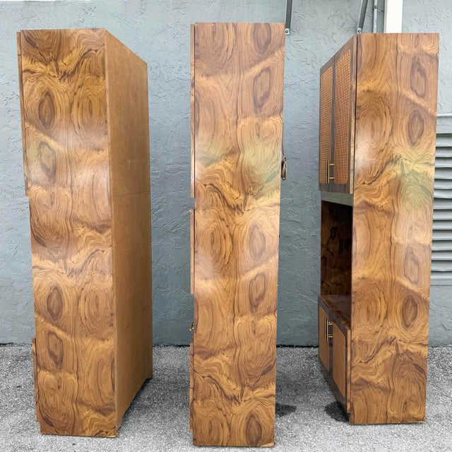 This three-piece mid century modern wall unit pairs high-gloss burlwood laminate with woven cane panels and brass accents...