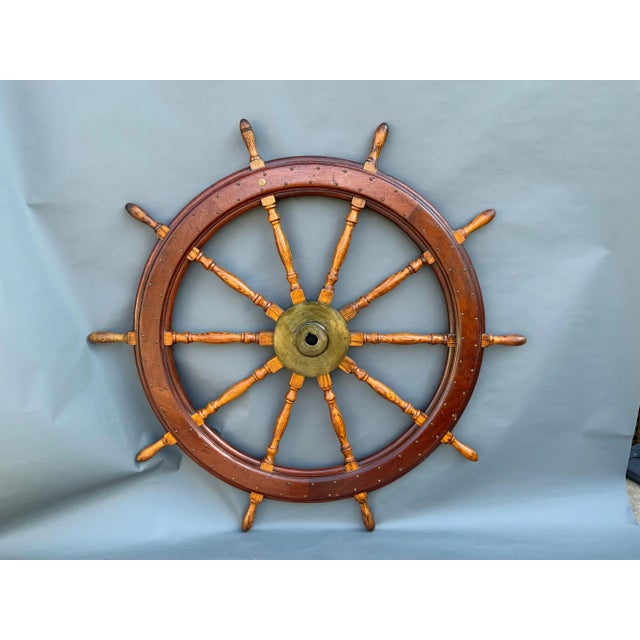 Large ten spoke ship's wheel by American Engineering Company of Philadelphia. Solid brass hub and maker's badge. The outer...