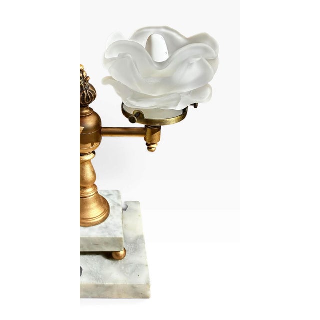 This is an Art Nouveau style double-light table lamp featuring frosted floral-shaped art glass shades (resembling tulip or...