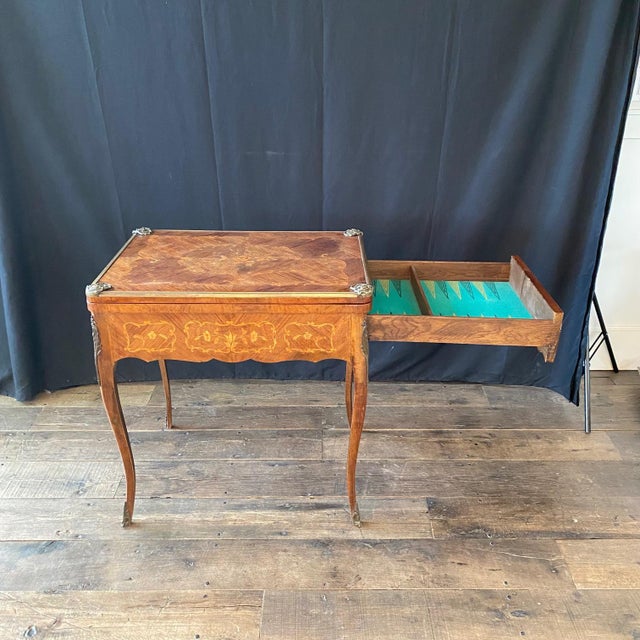 A truly fabulous 19th century French marquetry card table, the rectangular top centered with an inlaid cartouche and...