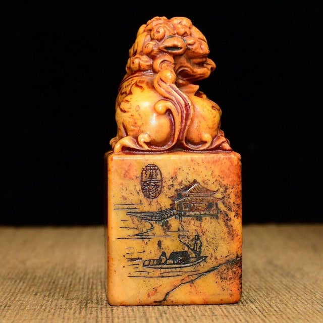 A substantial Chinese scholar's seal carved from Tianhuang Shoushan stone, topped with a finely modeled foo dog (guardian...