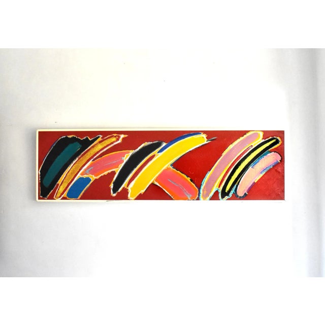 An original colorful abstract painting by Carol Geyer on a red background, with a white frame. Signed on the back. From...