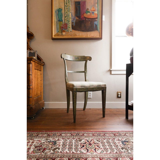 Painted side chair with a scrolled tablet crest rail and a single back rail, hand-decorated with floral sprays and fine...