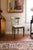 Painted side chair with a scrolled tablet crest rail and a single back rail, hand-decorated with floral sprays and fine...