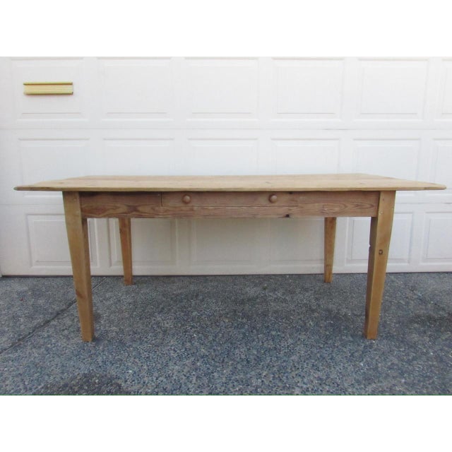 Antique English rustic pine farm table, c.1900 Rectangular in shape with a long deep drawer to the front and standing on...