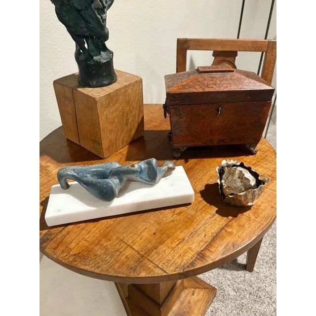 Abstract reclining female sculpture in the manner of Henry Moore with a blueish patina on a metal medium mounted to a...