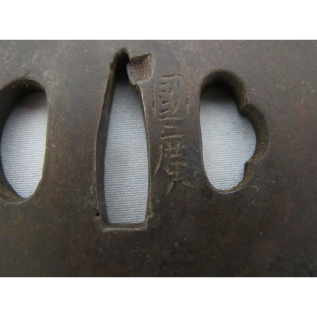 Antique Japanese hand forged iron Tsuba. Squared shape with etched signature at front. The design and craftsmanship...