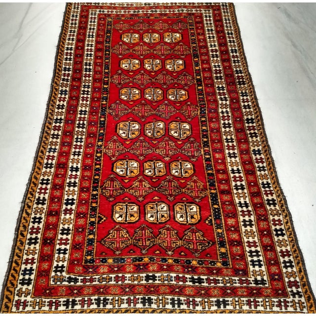 This authentic vintage Turkmen area rug from Central Asia, handwoven with precision in the second quarter of the 20th...