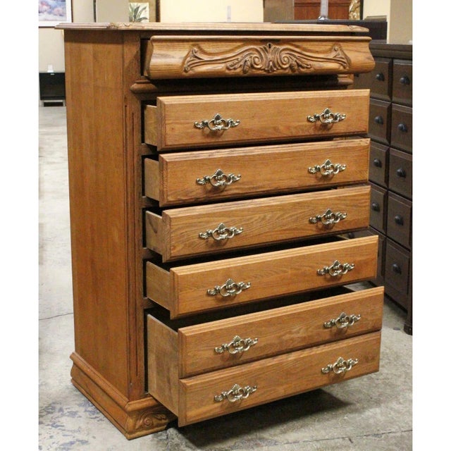 Crafted in a traditional rustic style, this piece features a warm oak finish with prominent grain patterns throughout....