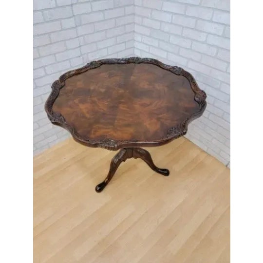 Vintage Georgian Style Flame Mahogany Carved Pie Crust Table by Maitland-Smith Beautiful carved acanthus leaf tri leg...