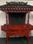Large Chinese altar shrine cabinet with extensive carved dragon decoration, architectural temple-style roof, pierced...