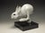 This bronze sculpture captures a dynamic moment of a hare in mid-leap, conveying a sense of energy and movement. The...