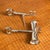 Clever decorative silver plated skeleton key design in this 1 and 1 1/2 ounce jigger with a bottle opener at the other...