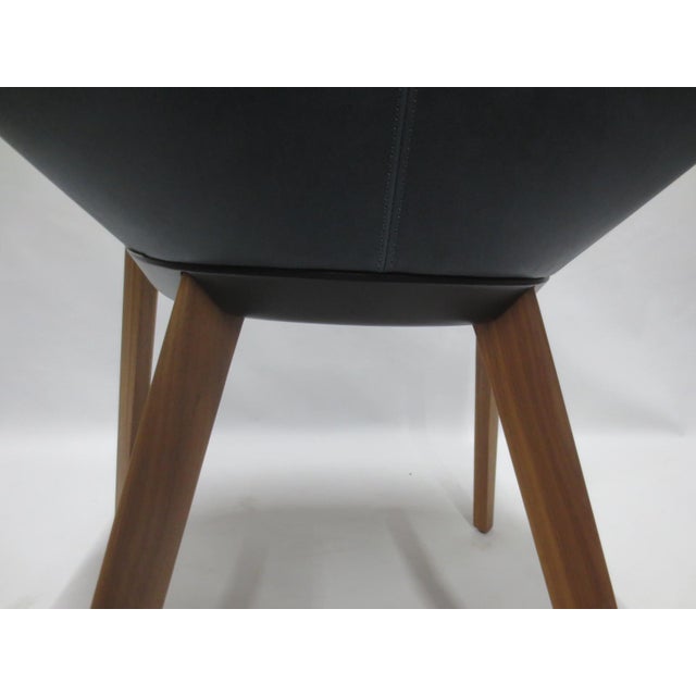 The Walter Knoll Sheru Armchair in grey fabric is a contemporary piece designed by EOOS, offering a sleek and minimalist...