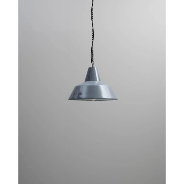 An industrial style metal lighting fixture created in 20th century France. Neatly composed and satisfyingly minimal, this...