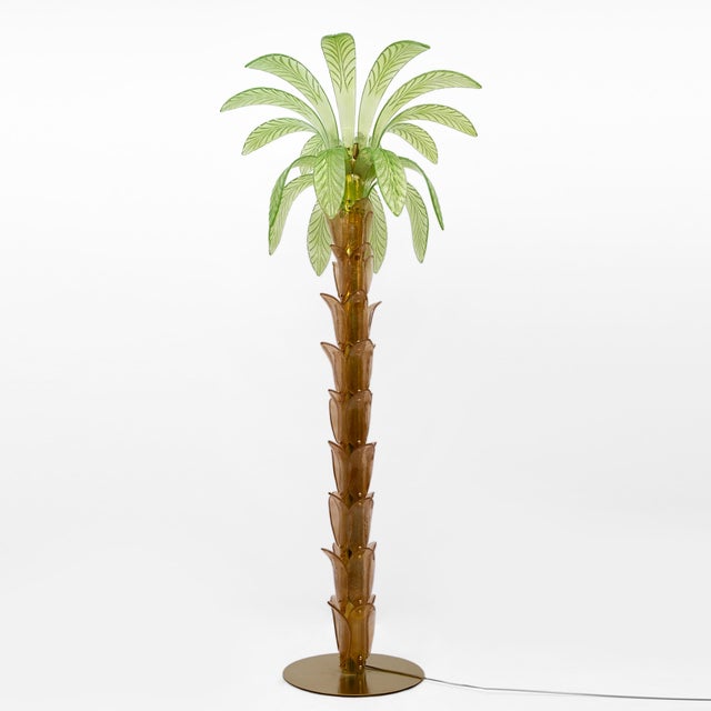 Pair of floor lamps in hand-blown murano glass in amber and green, the structure is in brass, four bulbs. the floor lamp...