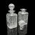 This is an antique decanter service. An English, crystal glass pair of spirit vessels upon a walnut plinth by Mappin &...