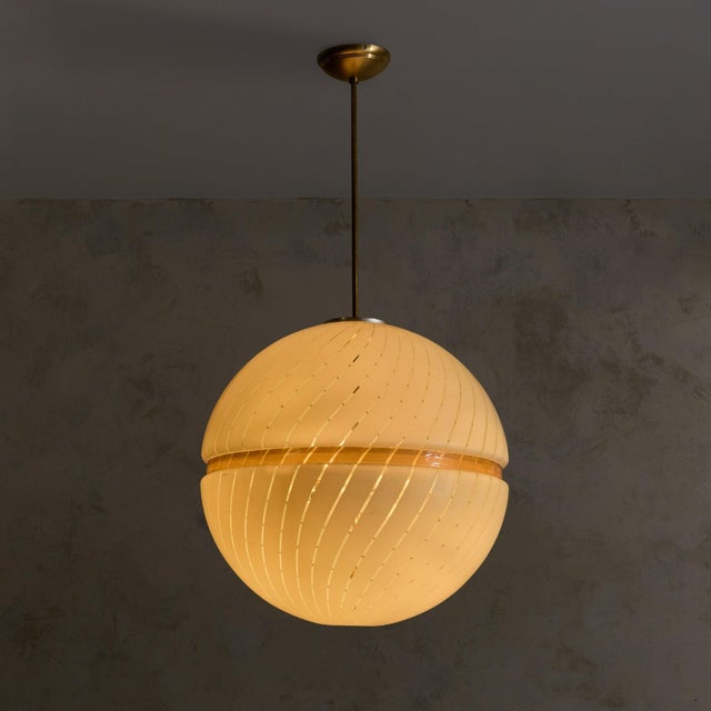 Designed in Italy during the 1970s, this pendant is composed of two acrylic hemispheres joined in quiet symmetry, an...