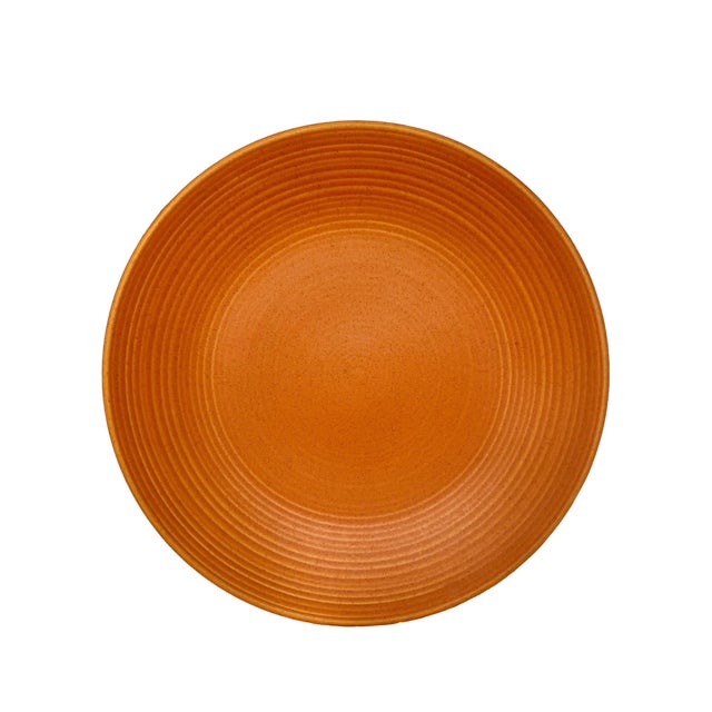 In vibrant apricot, this mid-century stoneware seehh by ice for four promises to add a splash of color to your table top!...