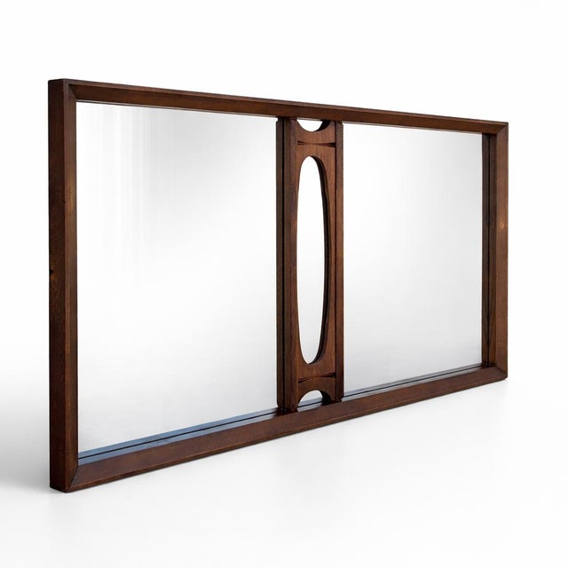 Vintage Canadian Brutalist wall mirror by Tobago of Canada, designed with a warm walnut-toned frame and a sculptural...