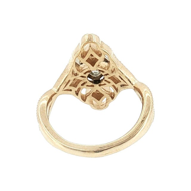 A 21st-century 14k gold vintage-style ring featuring a central 1.06 carat cushion-cut diamond, surrounded by intricate...