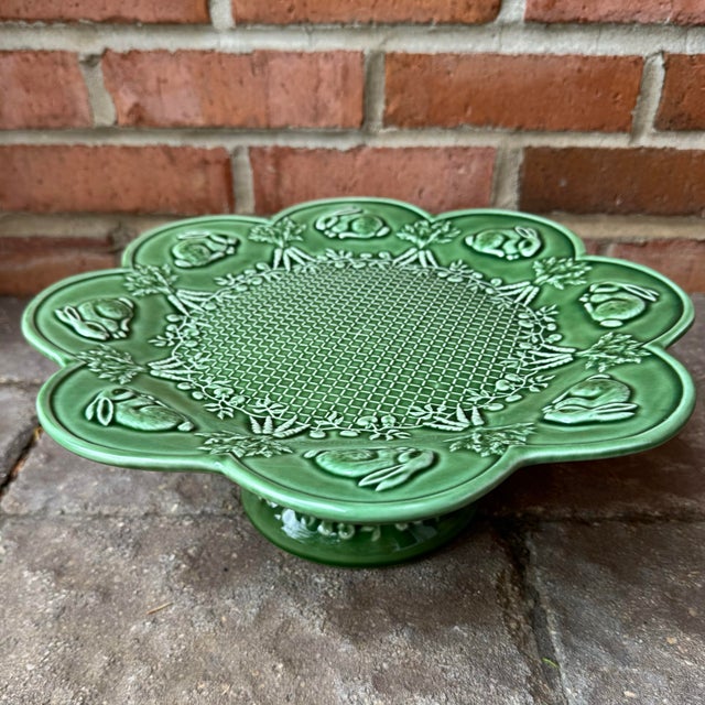 Classic green Bordallo Pinheiro pedestal cake stand featuring bunnies, carrot bunches and a basket weave surface. Perfect...