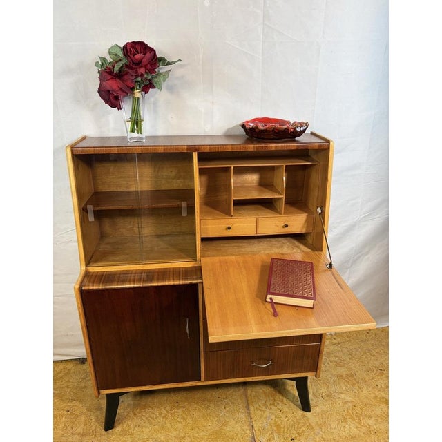 A fantastic and versatile mid century modern teak bureau bookcase dating from the 1960s, combining stylish design with...