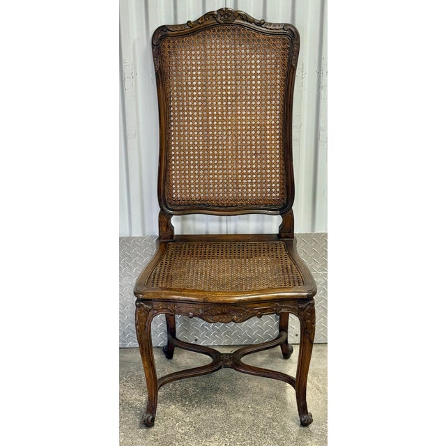 Gorgeous set of Louis XV style chairs. Features an elegantly carved, tall, and slightly arched back with a decorative...