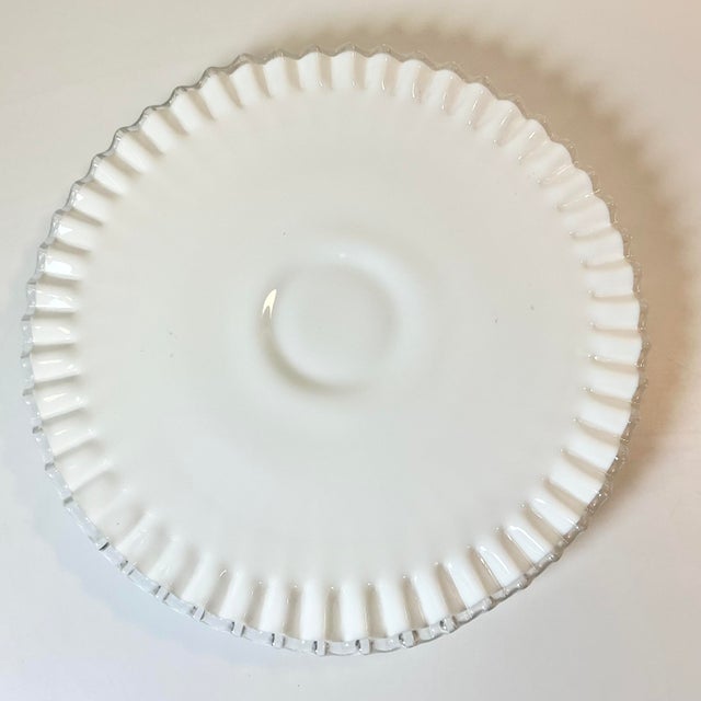 Fenton is famous for their Silver Crest Ruffle edge Milk Glass Collection. This is a low-rise footed Cake Stand from this...