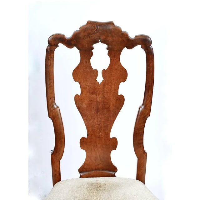 This is a great example of an early 18th century Queen Anne Side Chair. The walnut frame together with the elegantly...