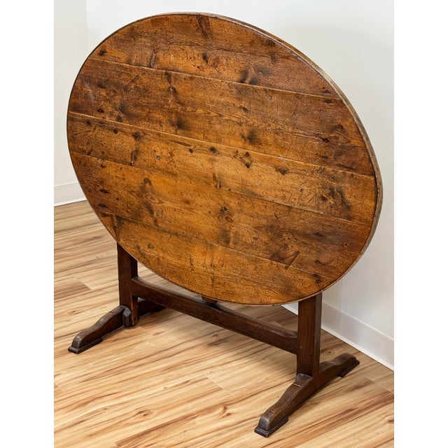Antique French Country style tilt-topped wine tasting table. Used by wine-makers throughout France, these tables feature...