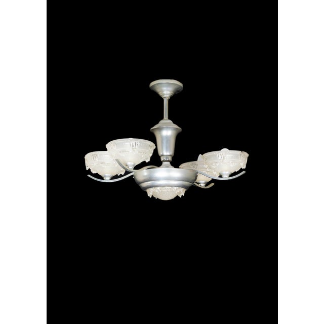 An Art Deco bistro chromed color four arms chandelier with frosted glass. Up to 250V (Europe/UK Standard).The wiring of...
