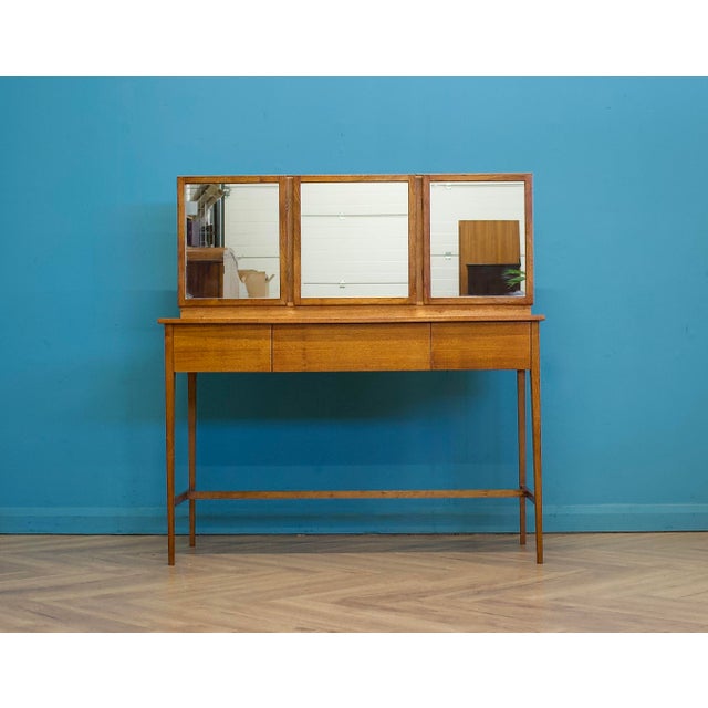 1960s mid century dressing table in walnut veneer with a clean Heal’s-style design, slim tapered legs and floating drawer...