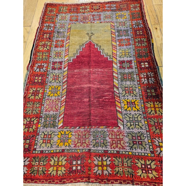 This vintage Turkish Anatolian area rug from the early 20th century features a beautifully executed prayer Mihrab design...