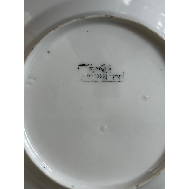 An elegant French porcelain dinner service, stamped Edmond Honoré in Paris, dating from the late 19th century, circa 1880....