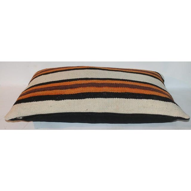 Hand Woven rug custom made pillow with black linen backing. New feather and down insert.