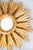 A stunning large vintage Mid-20th Century French gilded wood sunburst mirror. The gorgeous mirror has a lovely gilt patina...